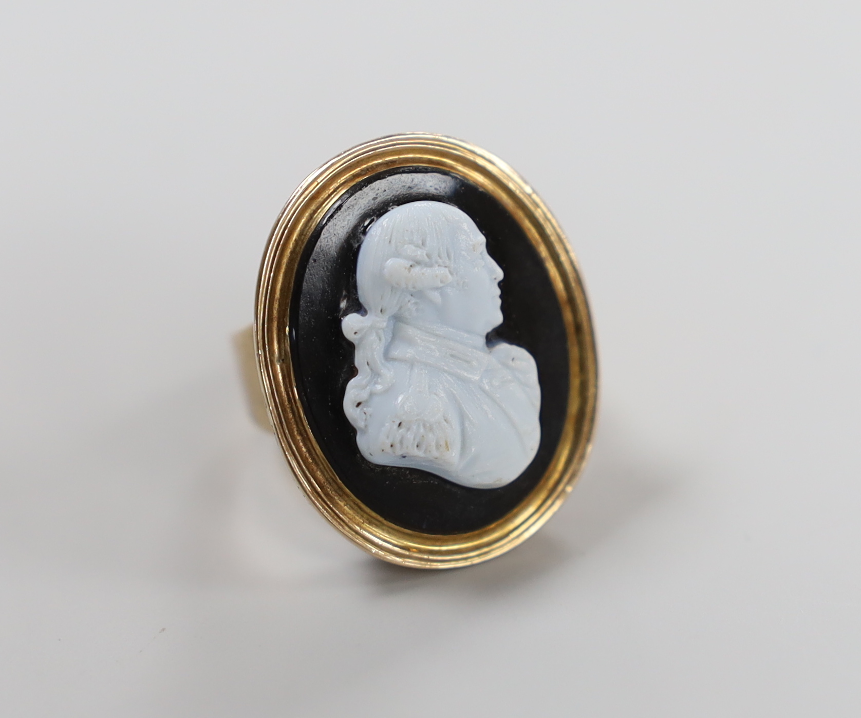 A 19th century and sardonyx cameo set oval ring, carved with the bust of a gentleman to sinister, size F/G, gross weight 8.9 grams.
